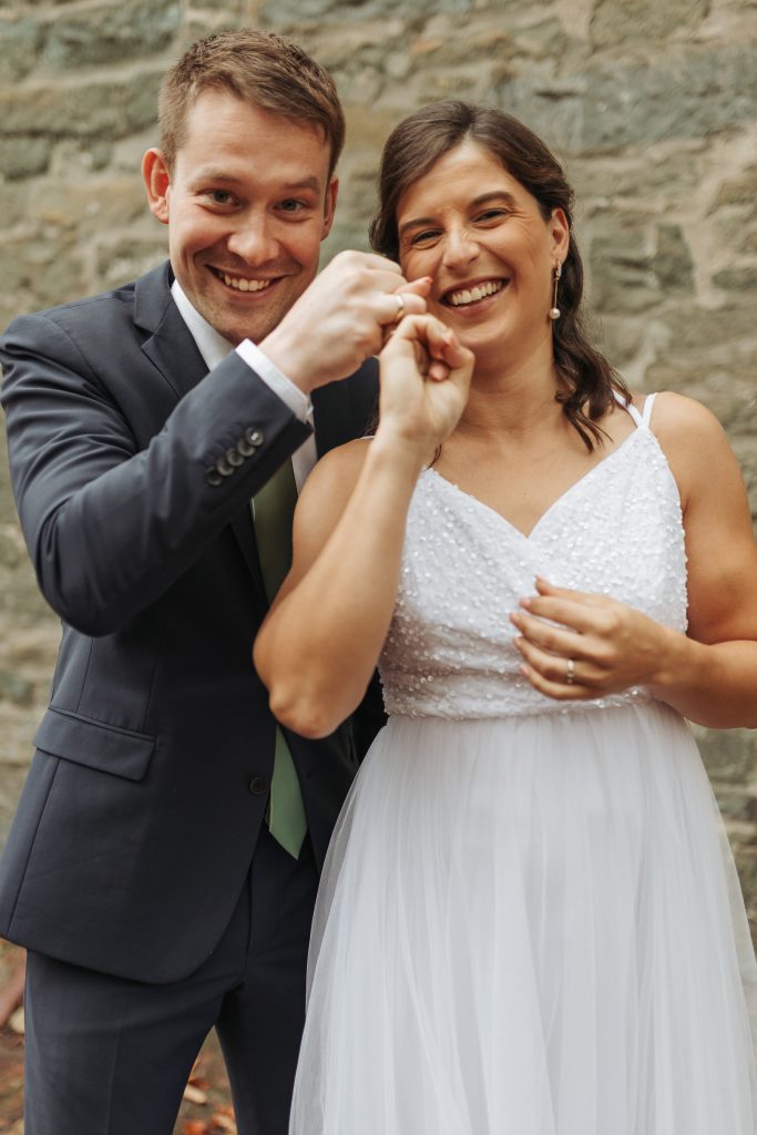 stolzes Brautpaar präsentieren ihre Ringe nach der Trauung in Freiburg